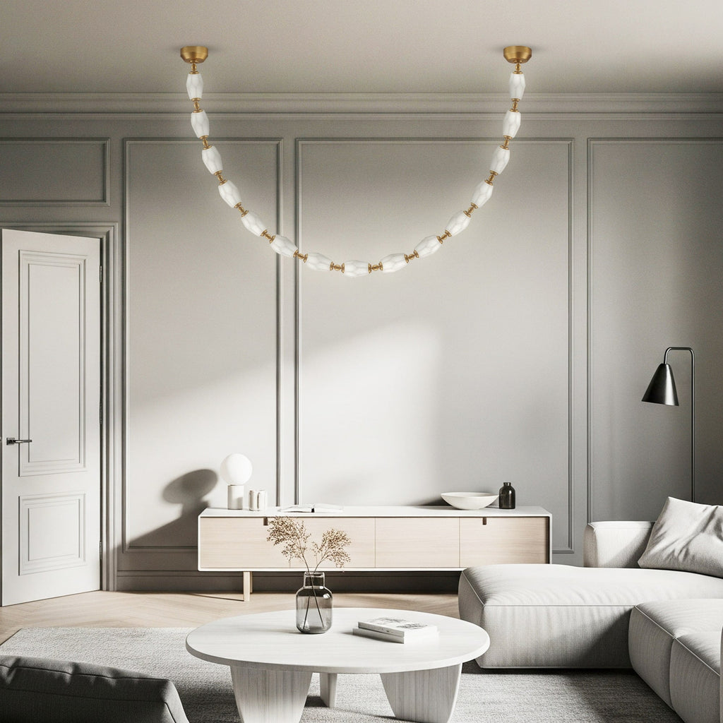 Curved alabaster and brass chandelier with sculptural design and soft, dimmable LED glow.