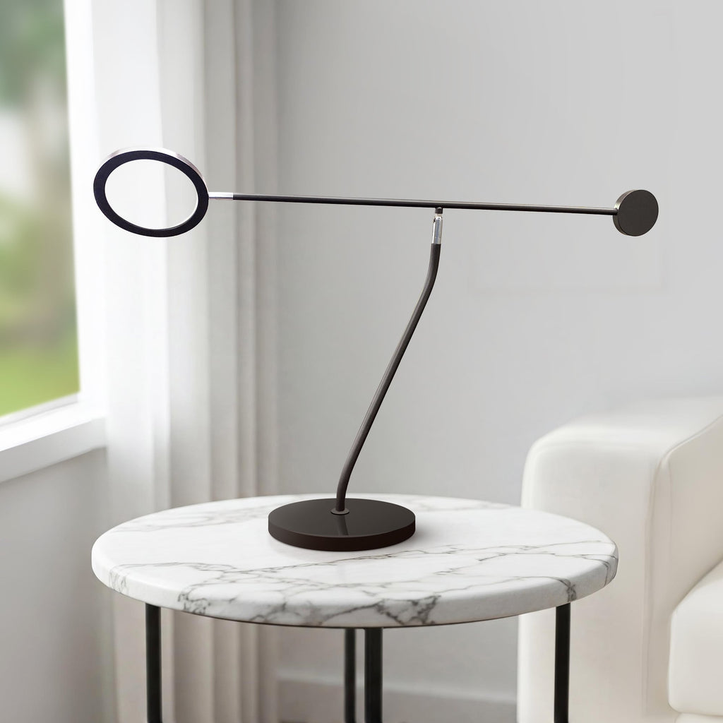 Matte black LED table lamp with adjustable ring arm, ideal for desks or nightstands.